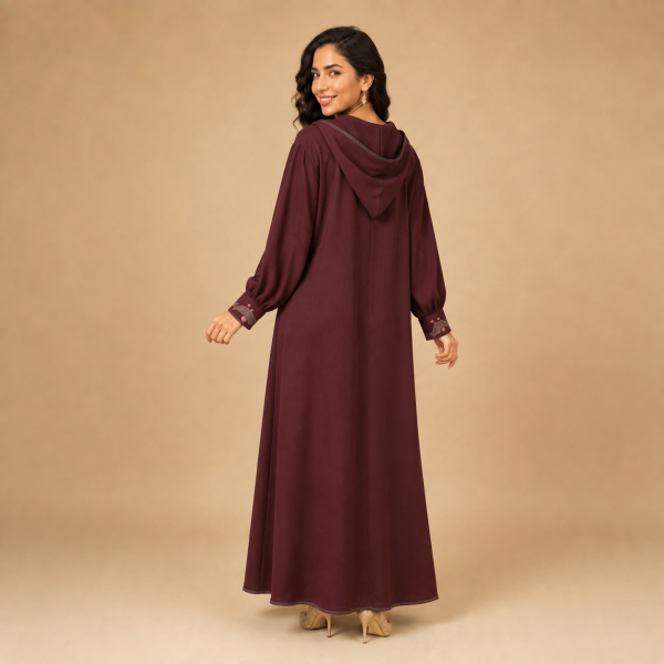 Back view of a burgundy Moroccan djellaba with a pointed hood, gathered sleeves and decorated cuffs