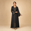 Back view of a black Moroccan djellaba with a pointed hood and triangular copper and teal sleeve panels
