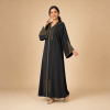 Back view of a black Moroccan djellaba with a pointed hood and triangular copper and teal sleeve panels