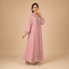 Back view of a dusty pink Moroccan djellaba with a pointed hood, grey edging and decorated cuffs