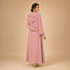 Back view of a dusty pink Moroccan djellaba with a pointed hood, grey edging and decorated cuffs