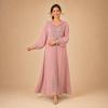 Back view of a dusty pink Moroccan djellaba with a pointed hood, grey edging and decorated cuffs