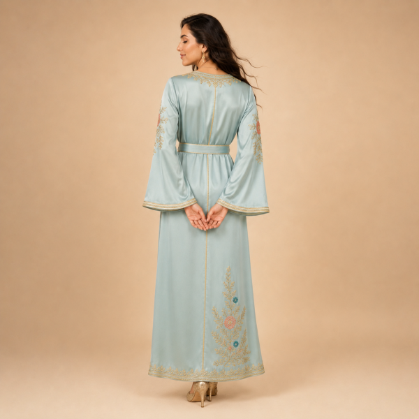 Back view of a powder blue Moroccan caftan with floral details, decorated sleeves and a matching belt