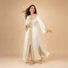 37 Back view of an ivory Moroccan caftan with gold sleeve details and an ornamental lower-side design