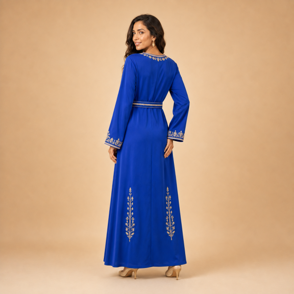 59 Back view of a royal blue Moroccan caftan with gold botanical motifs on the lower skirt and decorated cuffs