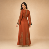 64 Back view of a copper orange Moroccan caftan with geometric gold-tone motifs, decorated sleeves and a matching belt