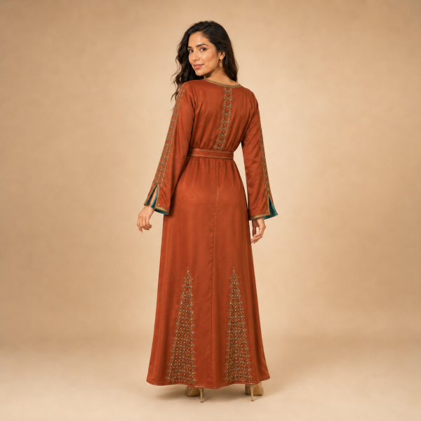 64 Back view of a copper orange Moroccan caftan with geometric gold-tone motifs, decorated sleeves and a matching belt