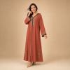 Back view of a terracotta Moroccan djellaba with a pointed hood, floral hood edging and green centre trim