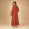 Back view of a terracotta Moroccan djellaba with a pointed hood, floral hood edging and green centre trim