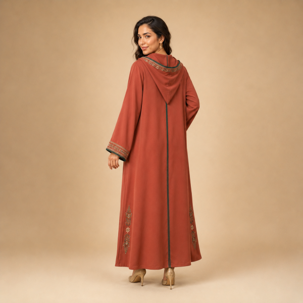 Back view of a terracotta Moroccan djellaba with a pointed hood, floral hood edging and green centre trim