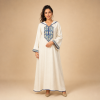 86 Back view of an ivory Moroccan djellaba with blue edging, patterned cuffs and a pointed hood with a small geometric accent